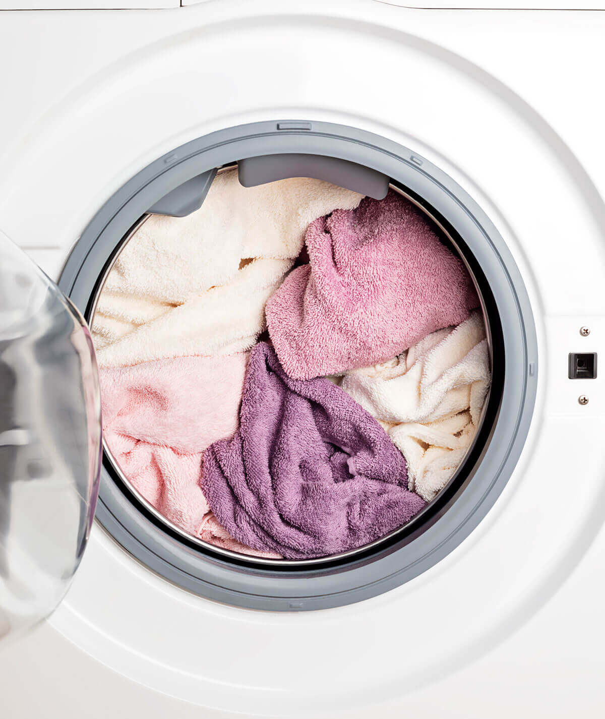 HE washing machine door open full of laundry
